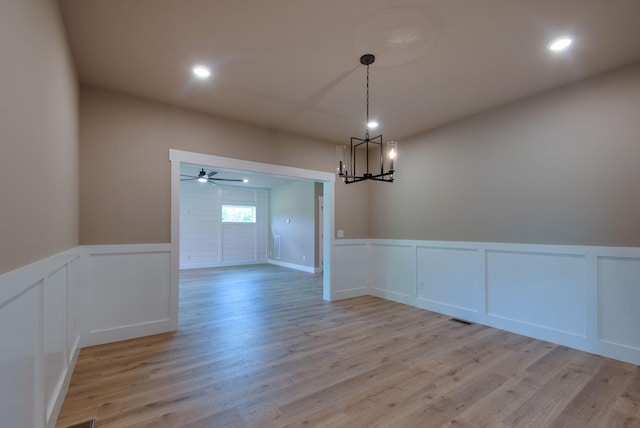 1151 Canaan Rd, Columbia, TN 38401 - empty room featuring a decorative wall, a chandelier, light wood finished floors, wainscoting, and recessed lighting
