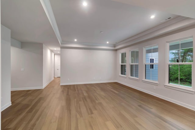 unfurnished room featuring wood finished floors, baseboards, ornamental molding, recessed lighting, and a raised ceiling