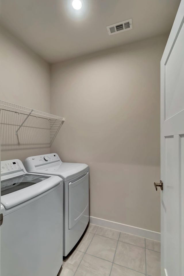 laundry area with washing machine and dryer and baseboards