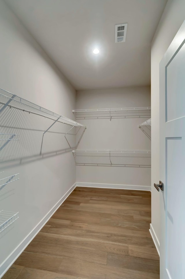 spacious closet featuring wood finished floors