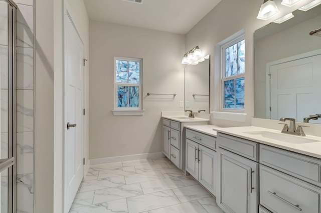 full bath with marble finish flooring, baseboards, vanity, and a shower