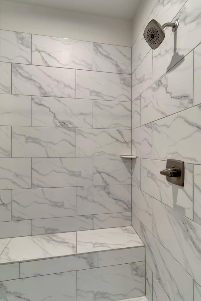 full bath featuring tiled shower