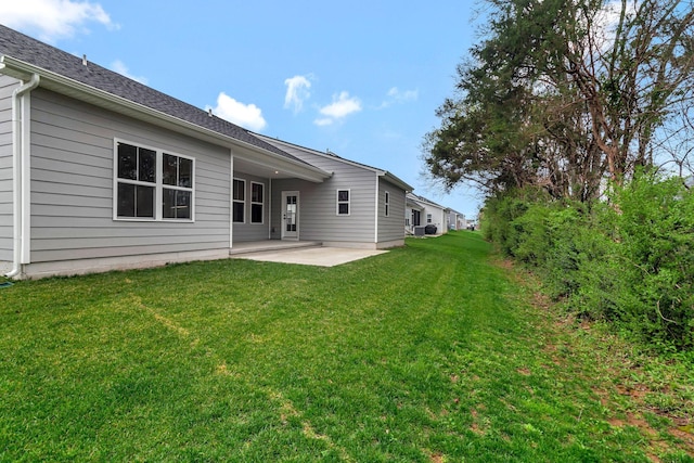 back of house featuring a patio and a lawn
