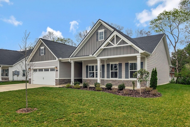 craftsman-style home featuring board and batten siding, driveway, stone siding, a front lawn, and roof with shingles