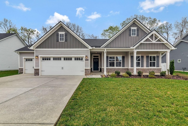 craftsman inspired home with board and batten siding, stone siding, an attached garage, and concrete driveway