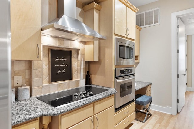 2600 Hillsboro Pike Unit 204, Nashville, TN 37212 - kitchen with wall chimney exhaust hood, light brown cabinetry, stainless steel appliances, visible vents, and decorative backsplash