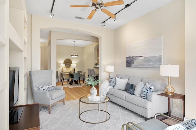 2600 Hillsboro Pike Unit 204, Nashville, TN 37212 - living area featuring visible vents, track lighting, ceiling fan, wood finished floors, and arched walkways