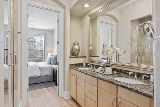 2600 Hillsboro Pike Unit 204, Nashville, TN 37212 - ensuite bathroom featuring ensuite bathroom, a sink, a stall shower, and wood finished floors