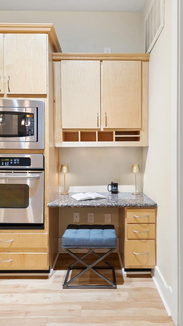 2600 Hillsboro Pike Unit 204, Nashville, TN 37212 - kitchen with built in study area, visible vents, light brown cabinetry, and appliances with stainless steel finishes