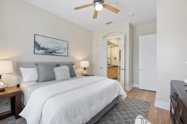 2600 Hillsboro Pike Unit 204, Nashville, TN 37212 - bedroom with connected bathroom, wood finished floors, baseboards, visible vents, and ceiling fan
