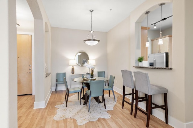 2600 Hillsboro Pike Unit 204, Nashville, TN 37212 - dining area featuring arched walkways, rail lighting, baseboards, and light wood-style floors