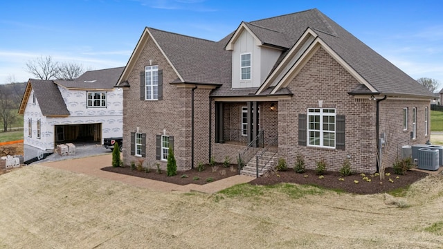 1121 Joe Martin Ln, Lebanon, TN 37087 - view of front of home with brick siding, central AC unit, and roof with shingles