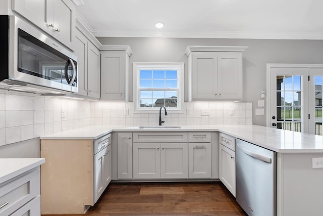 1121 Joe Martin Ln, Lebanon, TN 37087 - kitchen with crown molding, a peninsula, a sink, and stainless steel appliances