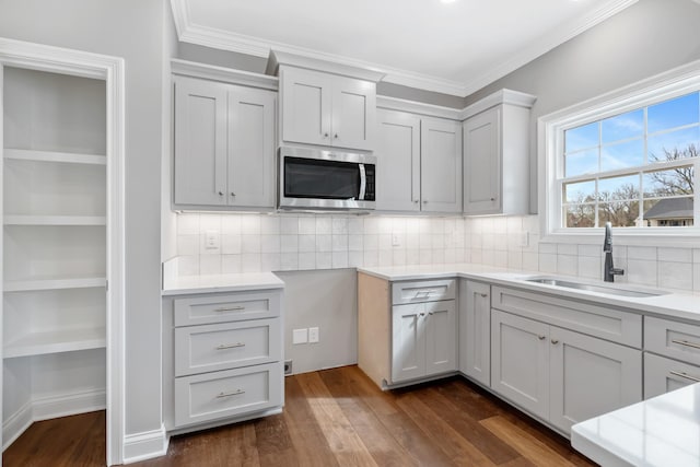 1121 Joe Martin Ln, Lebanon, TN 37087 - kitchen featuring stainless steel microwave, ornamental molding, dark wood finished floors, backsplash, and a sink