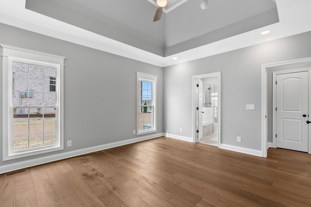 1121 Joe Martin Ln, Lebanon, TN 37087 - unfurnished bedroom featuring baseboards, a raised ceiling, connected bathroom, visible vents, and wood finished floors