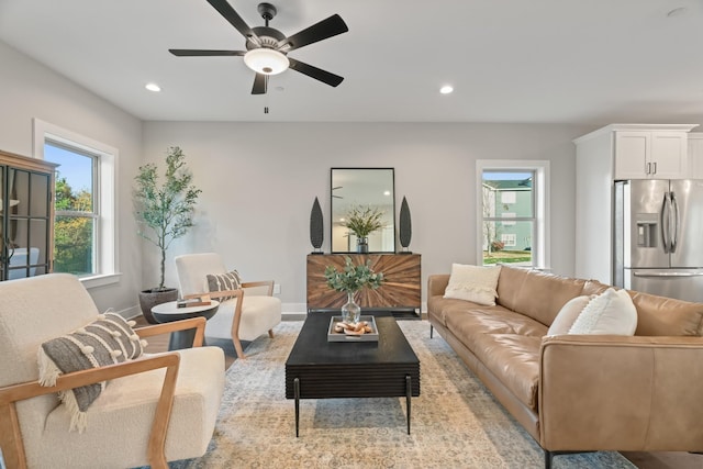 living area featuring baseboards, ceiling fan, and recessed lighting