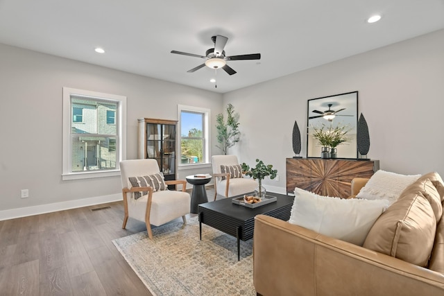 living area featuring visible vents, wood finished floors, recessed lighting, and a ceiling fan