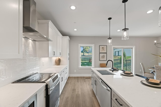 205 Charlotte Everly Cir, Hendersonville, TN 37075 - kitchen with decorative backsplash, stainless steel appliances, white cabinetry, a sink, and wall chimney range hood