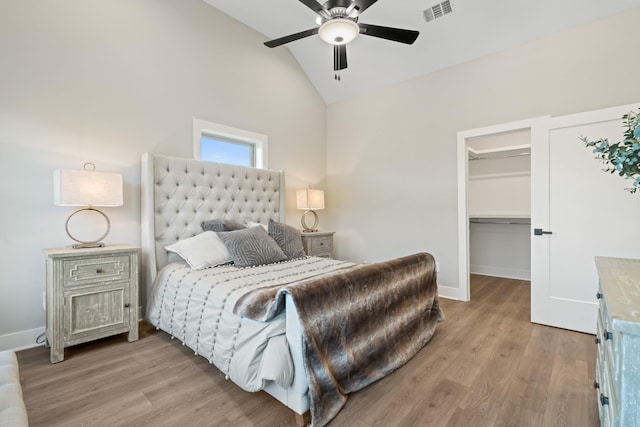 205 Charlotte Everly Cir, Hendersonville, TN 37075 - bedroom with visible vents, wood finished floors, a walk in closet, and vaulted ceiling