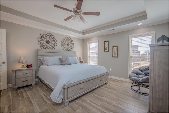 bedroom with crown molding, baseboards, a ceiling fan, a raised ceiling, and wood tiled floor
