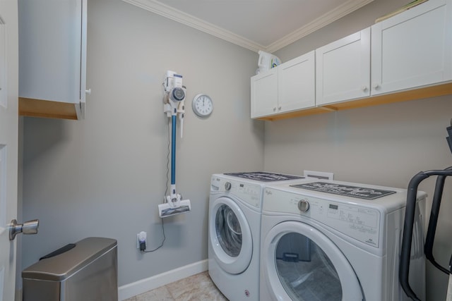 laundry area with baseboards, cabinet space, washing machine and dryer, and ornamental molding