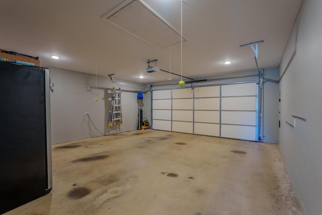 garage with a garage door opener and freestanding refrigerator