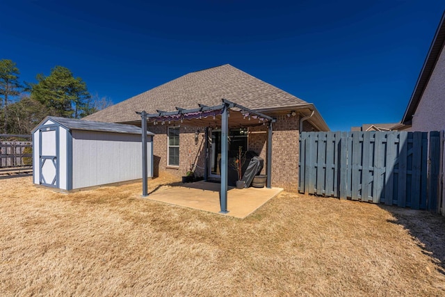 rear view of house featuring a patio area, an outdoor structure, a fenced backyard, a pergola, and a storage unit