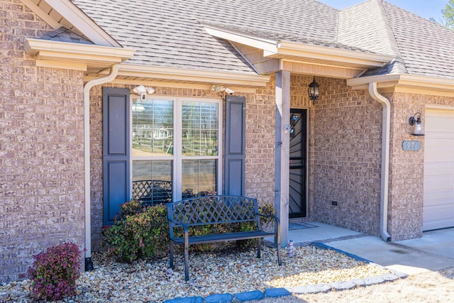 property entrance with brick siding, a porch, roof with shingles, and an attached garage