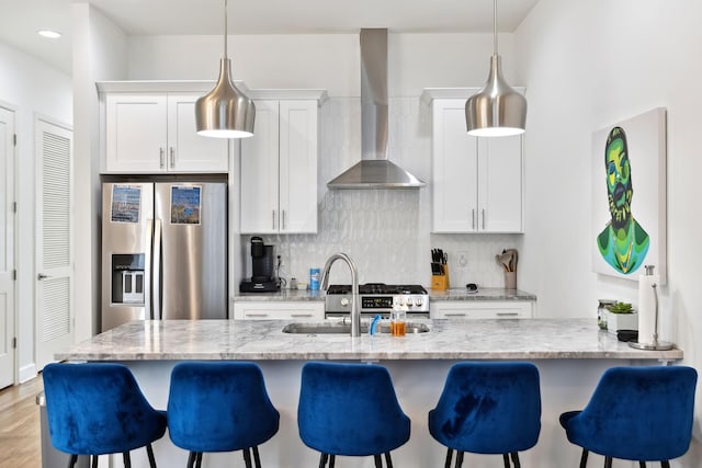 1930D Herman St, Nashville, TN 37208 - kitchen with backsplash, white cabinetry, wall chimney exhaust hood, a kitchen bar, and stainless steel fridge