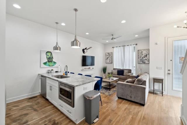 1930D Herman St, Nashville, TN 37208 - kitchen with open floor plan, stainless steel appliances, a sink, a peninsula, and wood finished floors