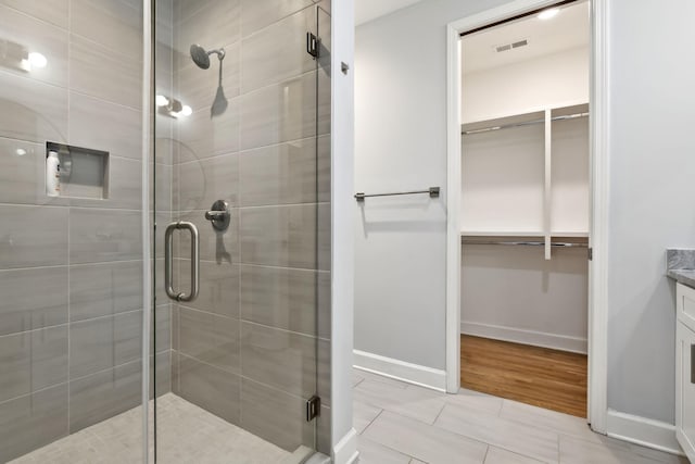 1930D Herman St, Nashville, TN 37208 - full bath featuring baseboards, a stall shower, and a walk in closet