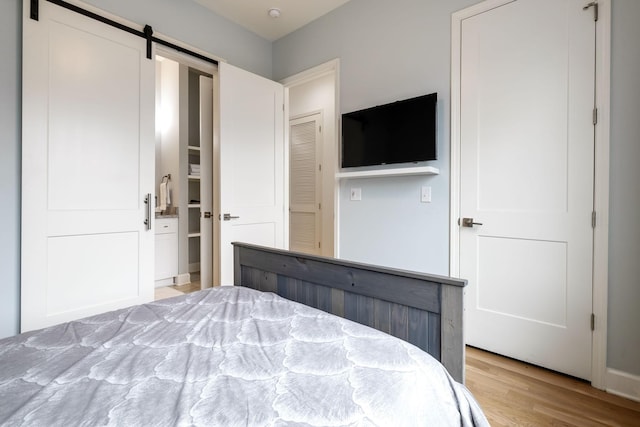 1930D Herman St, Nashville, TN 37208 - unfurnished bedroom with light wood finished floors and a barn door