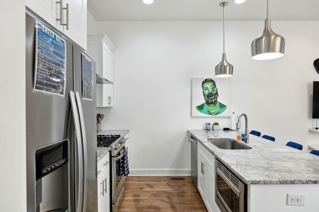 1930D Herman St, Nashville, TN 37208 - kitchen featuring a sink, light stone countertops, a peninsula, stainless steel appliances, and white cabinets