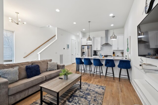 1930D Herman St, Nashville, TN 37208 - living room featuring stairway, a chandelier, light wood-style flooring, visible vents, and recessed lighting