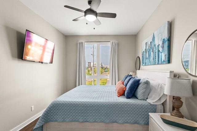 5403 Centennial Blvd Unit 203, Nashville, TN 37209 - bedroom with baseboards, wood finished floors, and a ceiling fan