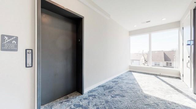 5403 Centennial Blvd Unit 203, Nashville, TN 37209 - unfurnished room with elevator, carpet floors, and baseboards