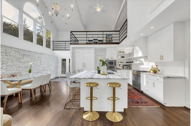 915 Overton Lea Rd, Nashville, TN 37220 - kitchen with high vaulted ceiling, appliances with stainless steel finishes, open shelves, dark wood-style flooring, and white cabinets