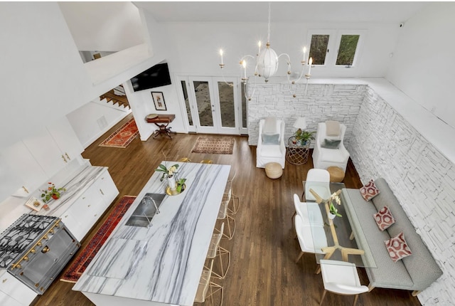 915 Overton Lea Rd, Nashville, TN 37220 - living area featuring french doors, wood finished floors, stairway, and a chandelier