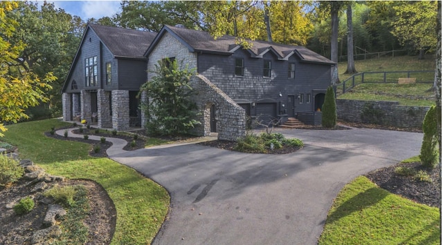 915 Overton Lea Rd, Nashville, TN 37220 - view of front facade featuring stone siding, driveway, and a garage