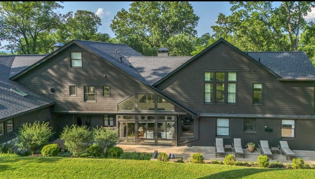 915 Overton Lea Rd, Nashville, TN 37220 - back of property with a patio, a shingled roof, a yard, and a chimney
