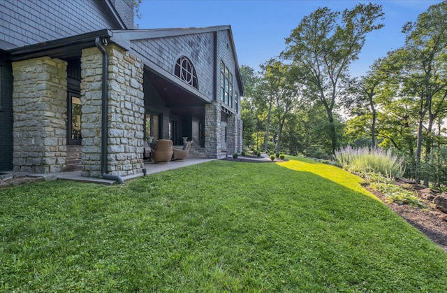 915 Overton Lea Rd, Nashville, TN 37220 - view of side of home featuring stone siding, a yard, and a patio area