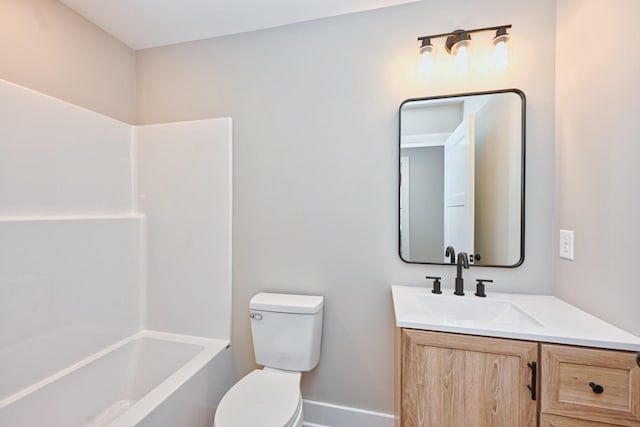 bathroom with shower / washtub combination, toilet, baseboards, and vanity