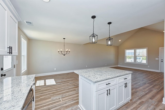kitchen with open floor plan, light wood-style flooring, and white cabinetry