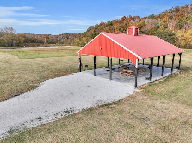 230 Anchor Dr, Waverly, TN 37185 - exterior space featuring driveway, a forest view, a carport, and a yard
