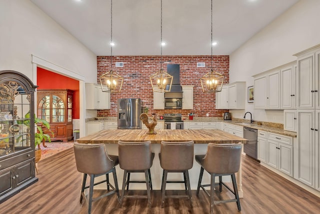 230 Anchor Dr, Waverly, TN 37185 - kitchen featuring a kitchen bar, butcher block countertops, appliances with stainless steel finishes, and a kitchen island