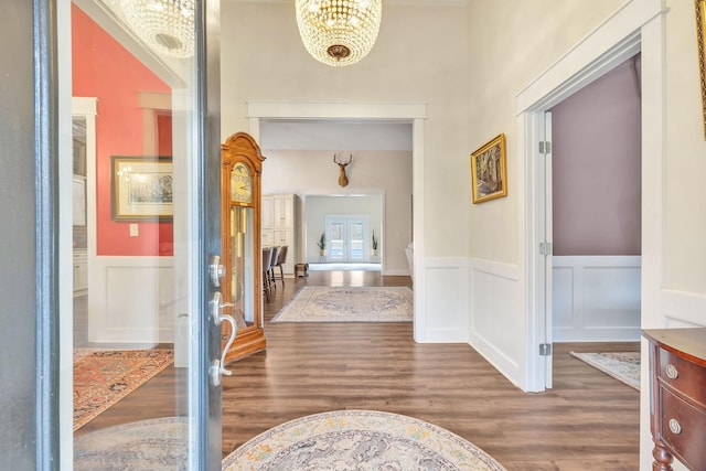 230 Anchor Dr, Waverly, TN 37185 - hallway with a wainscoted wall, a decorative wall, wood finished floors, and a chandelier