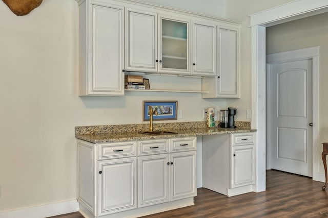 230 Anchor Dr, Waverly, TN 37185 - kitchen with dark wood-style flooring, glass insert cabinets, white cabinetry, a sink, and light stone counters