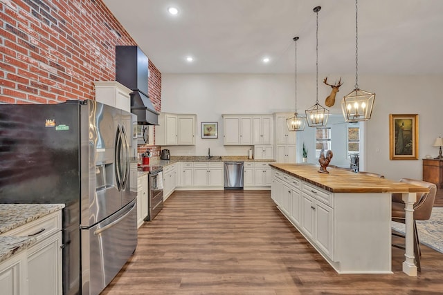 230 Anchor Dr, Waverly, TN 37185 - kitchen featuring an inviting chandelier, butcher block countertops, dark wood-type flooring, appliances with stainless steel finishes, and wall chimney exhaust hood