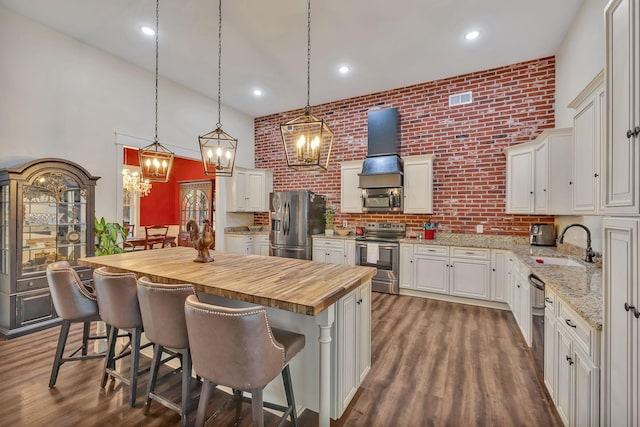 230 Anchor Dr, Waverly, TN 37185 - kitchen featuring premium range hood, butcher block countertops, a sink, visible vents, and appliances with stainless steel finishes