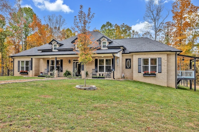 230 Anchor Dr, Waverly, TN 37185 - view of front of home with a front yard, a ceiling fan, brick siding, a porch, and a shingled roof